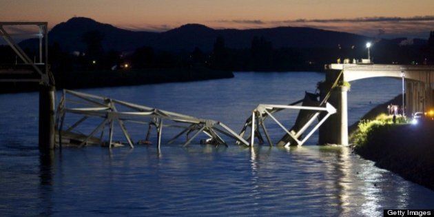 MT. VERNON, WASHINGTON - MAY 23: Crews survey the scene of a bridge collapse on Interstate 5 on May 23, 2013 near Mt. Vernon, Washington. I-5 connects Seattle, Washington to Vancouver B.C., Canada. No deaths have been reported, and three people were taken to hospitals with injuries. (Stephen Brashear/Getty Images)