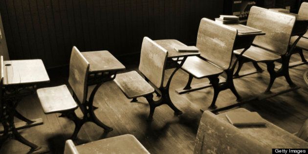 Old classroom student desks in a rural one room schoolhouse... Sepia with view from above.