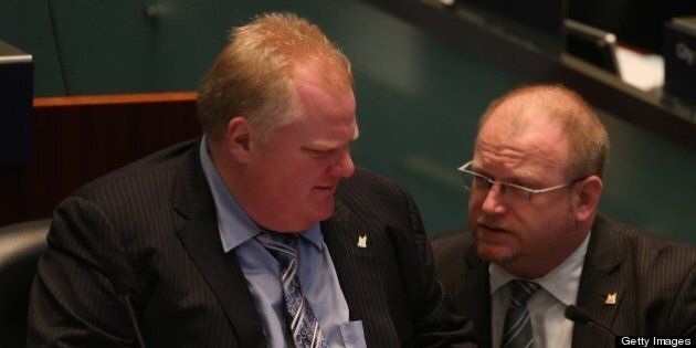 TORONTO, ON - MAY 21: Mayor Rob Ford talks to his chief of staff Mark Towhey in the council chamber for a special council meeting on the Casino debate in Toronto. (Steve Russell/Toronto Star via Getty Images)