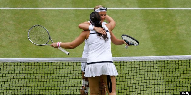 Belgium's Kirsten Flipkens (back) embraces France's Marion Bartoli (front) at the net after Bartoli's victory in their women's singles semi-final match on day ten of the 2013 Wimbledon Championships tennis tournament at the All England Club in Wimbledon, southwest London, on July 4, 2013. Bartoli won 6-1, 6-2. AFP PHOTO / POOL / KIRSTY WIGGLESWORTH - RESTRICTED TO EDITORIAL USE (Photo credit should read KIRSTY WIGGLESWORTH/AFP/Getty Images)