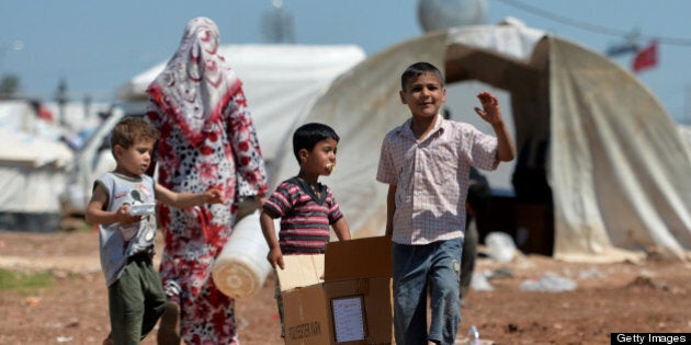 Internally displaced Syrian families spend their day at the Maiber al-Salam refugee camp along the Turkish border in the northern province of Aleppo on April 28, 2013. The number of Syrians who have fled their conflict-ravaged homeland has surpassed 1.4 million, the United Nations refugee agency said, warning that it was no longer able to meet their medical needs. AFP PHOTO /MIGUEL MEDINA (Photo credit should read MIGUEL MEDINA/AFP/Getty Images)