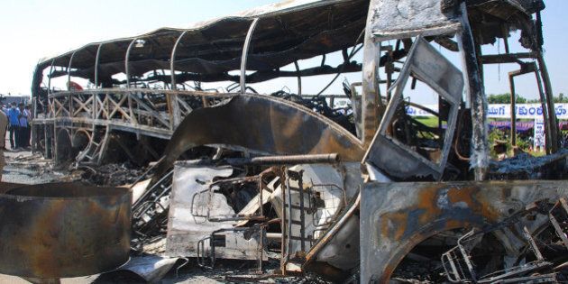 The skelatal remains of a burnt-out bus which was travelling from Bangalore to Hyderabad, are seen on the highway in Mahbubnagar district of the southern Andhra Pradesh state, about 140 kms from Hyderabad on October 30, 2013. A speeding bus exploded in a ball of flames after crashing into the central reservation of a southern Indian highway, killing 45 passengers as they slept. AFP PHOTO (Photo credit should read STR/AFP/Getty Images)