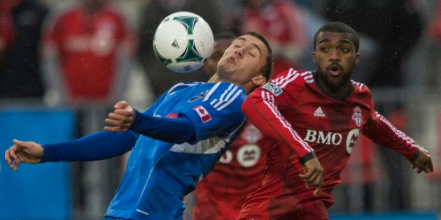 TORONTO - OCTOBER 26 - Montreals Andrew Wenger controls the ball in front of Doneil Henry of TFC. Toronto FC takes on Montreal Impact on October 26, 2013, at BMO Field for the last regular season game this year. TFC has one of the worst winning percentages ever, as they conclude another dismal year. (Rick Madonik/Toronto Star via Getty Images)