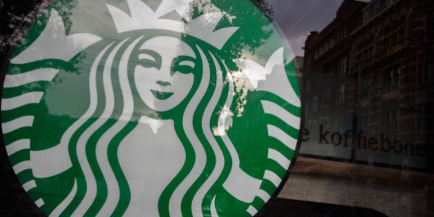 A logo sits on display in a window of a Starbucks Corp. store in Amsterdam, Netherlands, on Monday, Sept. 16, 2013. Global coffee supplies will outpace demand for a second year in the 2013-14 season that starts in October in most countries because of ample availability of arabica, according to Volcafe Ltd. Photographer: Jasper Juinen/Bloomberg via Getty Images