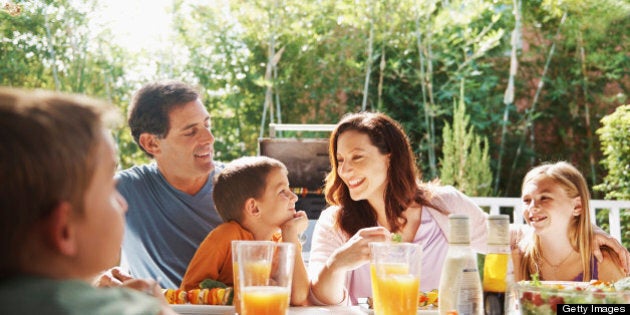 A loving family having a barbeque outside