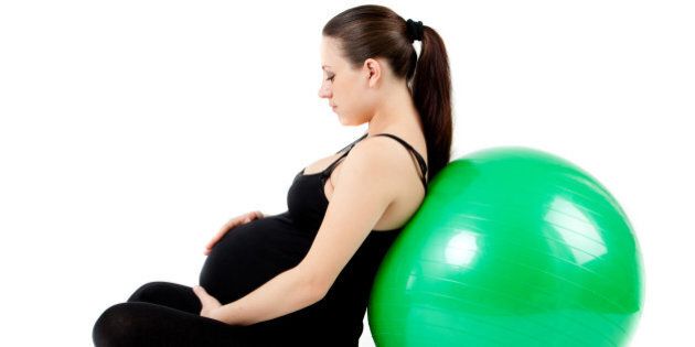 pregnant woman with gymnastic...