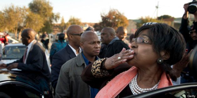 Winnie Madikizela Mandela blows a kiss to well wishers after addressing media outside their first family home in Soweto on June 28, 2013. Winnie Mandela said 'there is great improvement in his health' Mandela is receiving treatment at the Mediclinic heart hospital in Pretoria. Mandela's close family gathered yesterday at his rural homestead to discuss the failing health of the South African anti-apartheid icon who was fighting for his life in hospital. Messages of support poured in from around the world for the Nobel Peace Prize winner, who spent 27 years behind bars for his struggle under white minority rule and went on to become South Africa's first black president. AFP PHOTO / ODD ANDERSEN (Photo credit should read ODD ANDERSEN/AFP/Getty Images)