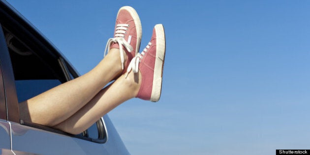 young woman relaxing in her car ...