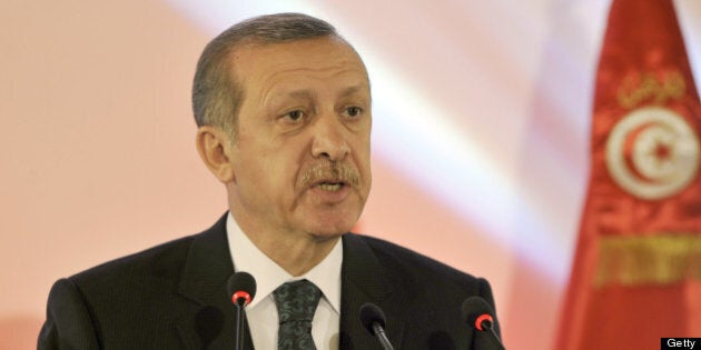 Turkish Prime Minister Recep Tayyip Erdogan speaks during a joint press conference with his Tunisian counterpart in Tunis on June 6, 2013. Erdogan said that members of a 'terrorist organisation' were taking part in deadly anti-government protests sweeping Turkey and refused to cancel a controversial Istanbul development plan that sparked them. AFP PHOTO / FETHI BELAID (Photo credit should read FETHI BELAID/AFP/Getty Images)