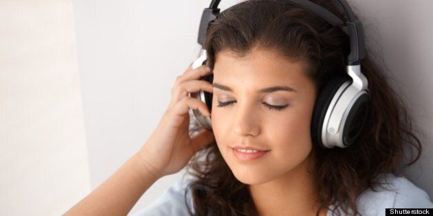 attractive schoolgirl listening ...