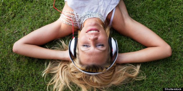 smiling woman in headphones on...