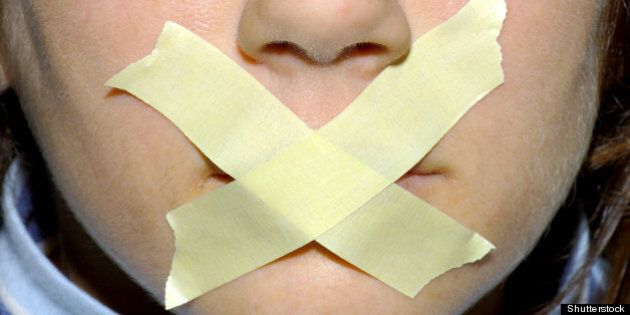 woman with tape on her mouth.