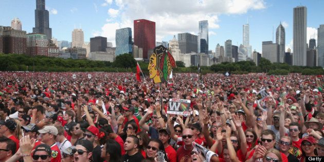 CHICAGO, IL - JUNE 28: Fans cheer during a rally for the Chicago Blackhawks at Grant Park on June 28, 2013 in Chicago, Illinois. The Blackhawks defeated the Boston Bruins in 6 games to win the National Hockey League's Stanley Cup for the second time in four seasons. (Photo by Scott Olson/Getty Images)