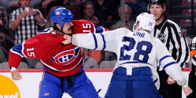 MONTREAL, QC - OCTOBER 1: George Parros #15 of the Montreal Canadiens and Colton Orr #28 of the Toronto Maple Leafs fight during the second period of the NHL game at the Bell Centre on October 1, 2013 in Montreal, Quebec, Canada. (Photo by Richard Wolowicz/Getty Images)