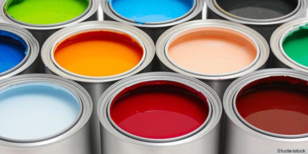 multicolored paint cans on white