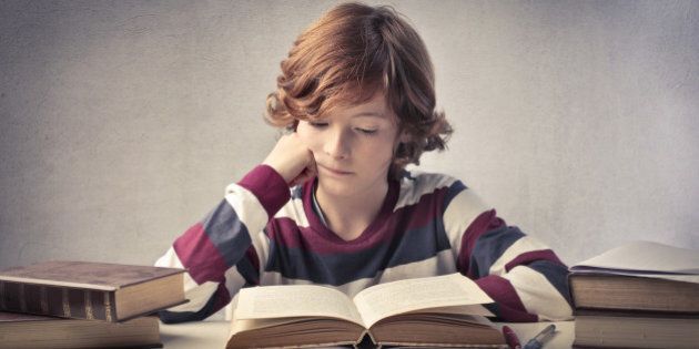 concentrated child reading a...