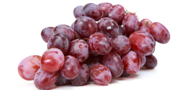 red grapes over white background