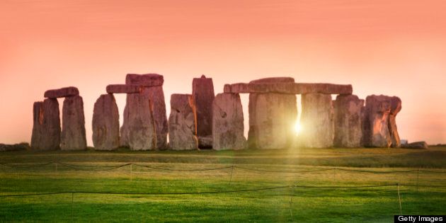 The prehistoric monument of Stonehenge in England. Focus is on the grass.