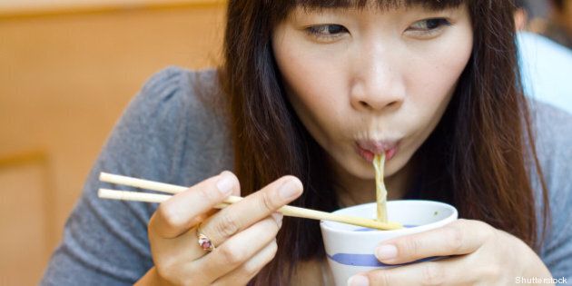 asian woman eating japanese...