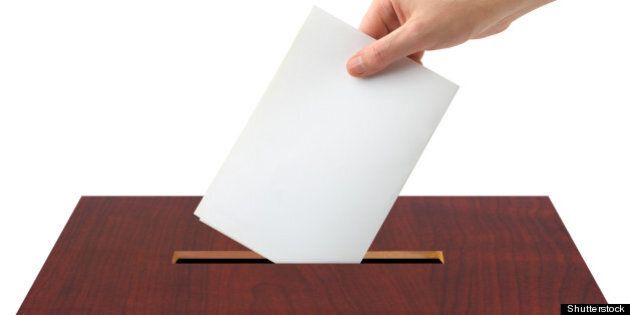 hand with ballot and box...
