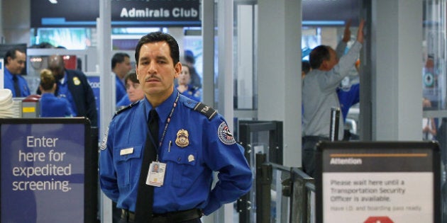 MIAMI, FL - OCTOBER 04: A TSA agent waits for passengers to use the TSA PreCheck lane being implemented by the Transportation Security Administration at Miami International Airport on October 4, 2011 in Miami, Florida. The pilot program launched today for fliers to use the expedited security screening in Miami, Atlanta, Detroit and Dallas/Fort Worth.The lane has a metal detector rather than a full-body imaging machine and passengers will no longer no need to remove shoes, belts, light outerwear, and bags of liquids that are compliant with TSA restrictions. (Photo by Joe Raedle/Getty Images)