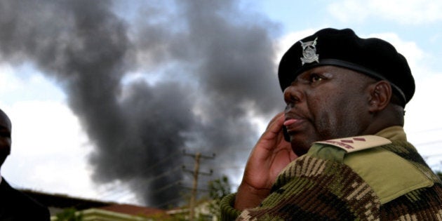 NAIROBI, KENYA - SEPTEMBER 23: (SOUTH AFRICA OUT) A police officer at the site of the terrorist attack, Westgate Mall, on September 23, 2013 in Nairobi, Kenya. The attack occurred on Saturday, 10-15 gunmen from the extremist group Al-Shabab entered the mall and opened fire at random on shoppers; 68 deaths have been confirmed. (Photo by Jeff Angote/Nation Media/Gallo Images/Getty Images)