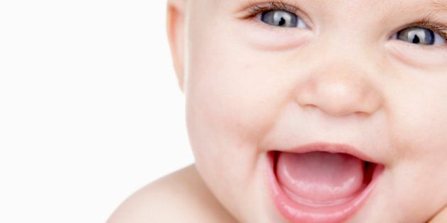 Baby boy (6-9 months) laughing, close up, portrait, studio shot