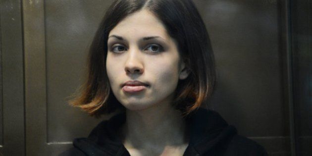 One of the jailed members of the all-girl punk band 'Pussy Riot,' Nadezhda Tolokonnikova, looks on while sitting in a glass-walled cage in a court in Moscow, on October 10, 2012. A Moscow court heard today the appeal of feminist punks Pussy Riot against their two-year prison camp sentence, days after President Vladimir Putin appeared to give his blessing to the verdict. AFP PHOTO / NATALIA KOLESNIKOVA (Photo credit should read NATALIA KOLESNIKOVA/AFP/GettyImages)