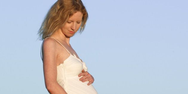 pregnant woman in white dress...