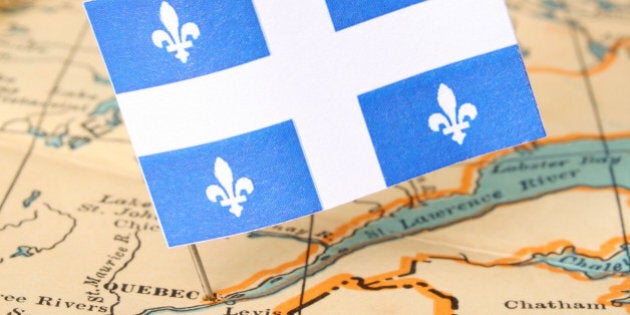 Quebec flag over more that sixty years old map pointing Quebec city. Shallow depth of field