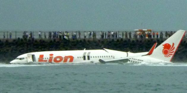 A Lion Air Boeing 737 lies submerged in the water after skidding off the runaway during landing at Bali's international airport near Denpasar on April 13, 2013. An Indonesian plane carrying more than 100 passengers broke in two after missing the runway at Bali airport on April 13 and landing in the sea, leaving dozens injured but no fatalities. AFP PHOTO/Karna Surya Putra (Photo credit should read Karna Surya Putra/AFP/Getty Images)