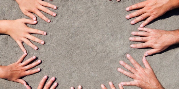 image of hands on sand ...