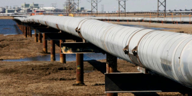 FILE - In this 2007 file photo, a new oil transit pipeline runs across the tundra to flow station at the Prudhoe Bay oil field on Alaska's North Slope. The oil pipeline that stretches 800 miles across the Alaska landscape is celebrating a milestone. The trans-Alaska oil pipeline on Wednesday marked 35 years in production with more than 16.5 billion barrels of oil loaded into the pipeline at Prudhoe Bay for delivery to Valdez, where it is loaded intotankers destined for the West Coast. (AP Photo/Al Grillo, File)