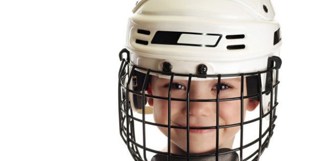 young boy in hockey helmet...