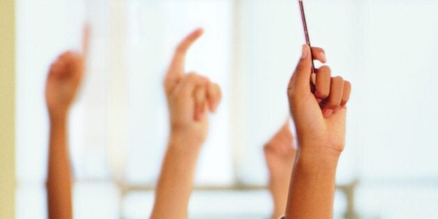 Students Raising Their Hands in a Classroom