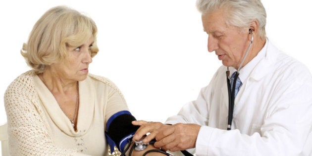 elderly doctor and patient on a ...