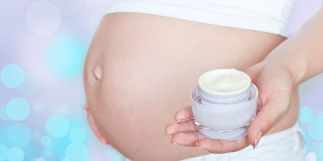 pregnant woman with body cream