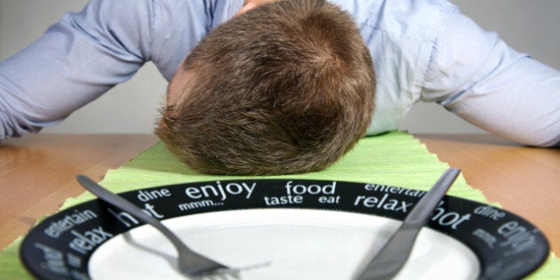 man falls asleep on a table...