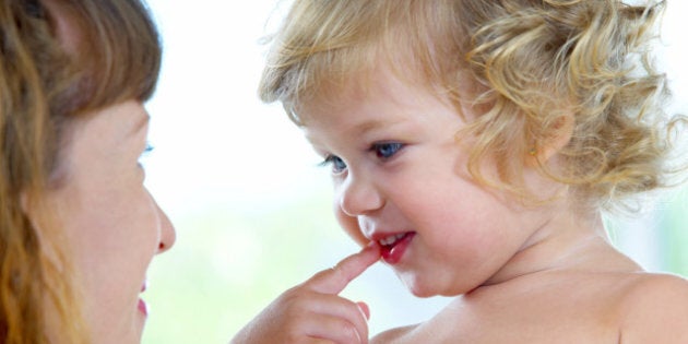 High key portrait of happy mother with baby