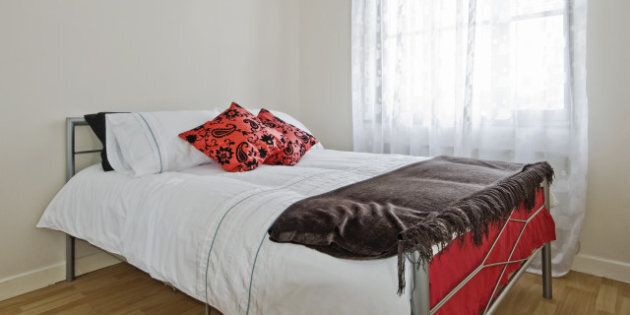 good size bedroom with double bed and red accessories