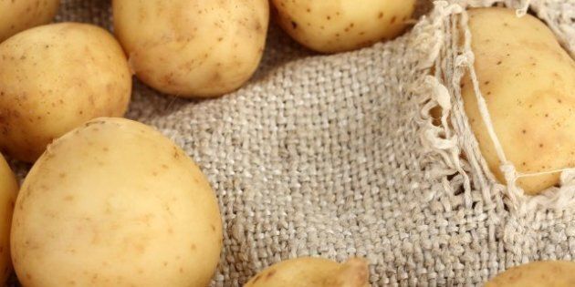 potatoes in a torn sack close up