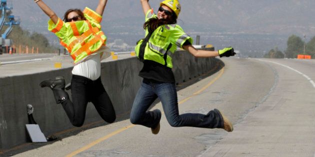 LOS ANGELES, CA - SEPTEMBER 29: Construction officials Kasey Shula (L) and Natasha Jones pose for a photo on the 405 Freeway as construction crews demolish a portion of the Mulholland Drive bridge along the 405 Freeway September 29, 2012 in Los Angeles, California. The 405 Freeway is completely shut down for a 10 mile stretch this weekend for the demolition that is part of a larger $1-billion freeway improvement project. (Photo by Jonathan Alcorn/Getty Images)
