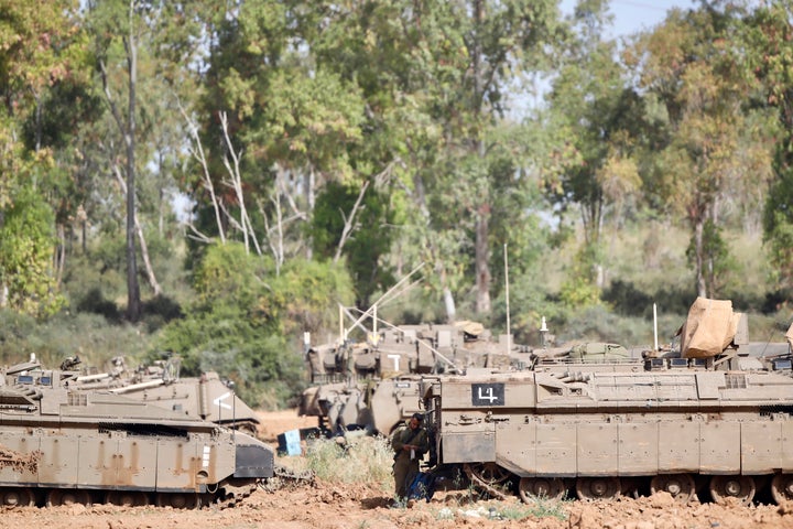 An Israeli soldier stands at a gathering point in Israel Gaza Border on Monday after a ceasefire mediated by Egypt took hold.