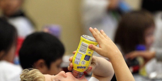 SAN FRANCISCO - NOVEMBER 12: A student at Fairmount Elementary School drinks a bottle of Nesquik chocolate milk during lunch hour on November 12, 2010 in San Francisco, California. San Francisco mayor Gavin Newsom announce today that he vetoed a controversial legislation that was approved by the San Francisco board of supervisors that would ban toys in fast food 'happy meals.' He promoted his 'Shape Up SF' program as a more effective way to combat childhood obesity by encouraging children to eat better, exercise and for schools to offer healthy food choices that include fresh vegetables. (Photo by Justin Sullivan/Getty Images)