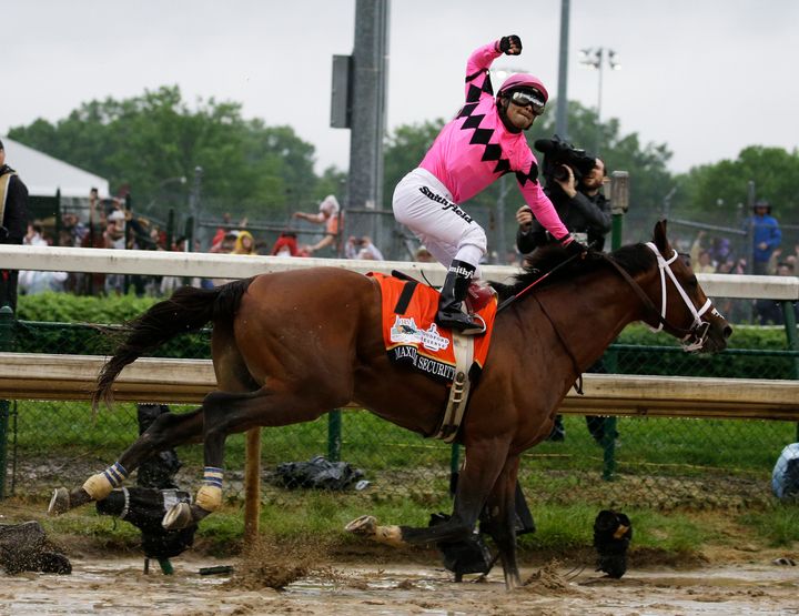 Luis Saez rides Maximum Security across the finish line of the Kentucky Derby on Saturday. Country House was later declared the winner after Maximum Security was disqualified.