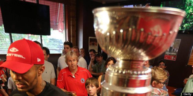 TORONTO, ON- JULY 13 - Philip Pritchard, one of three keepers of the puck looks on as former Chicago Blackhawk, now a Flyer, Ray Emery brings the Stanley Cup to Wayne Gretzky's restaurant in Toronto, July 13, 2013. (Steve Russell/Toronto Star via Getty Images)