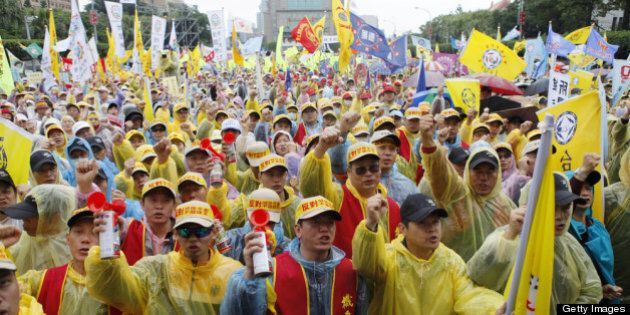 TAIPEI, TAIWAN - MAY 01: Over 20,000 workers stage a protest against President Ma Ying-jeou's pension reforms on Labor Day on May 1, 2013 in Taipei, Taiwan. The government's cabinet recently passed bills for restructuring various pension plans. (Photo by Ashley Pon/Getty Images)