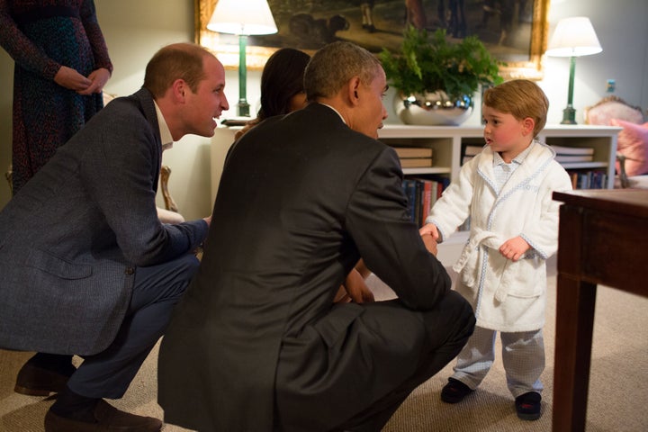 President Barack Obama, Prince William and First Lady Michelle Obama talk with Prince George at Kensington Palace on April 22, 2016 in London.