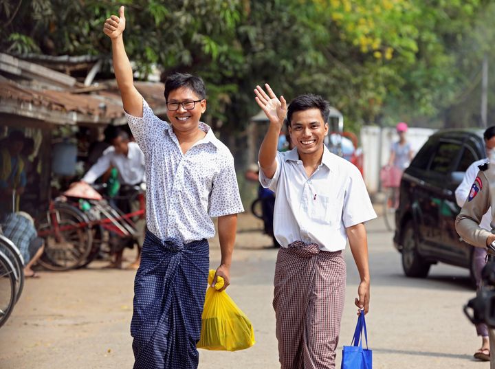 Reuters reporters Wa Lone and Kyaw Soe Oo gesture as they walk free outside Insein prison after receiving a presidential pardon in Yangon, Myanmar, May 7, 2019.