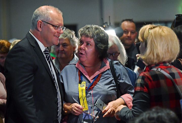 Australian Prime Minister Scott Morrison, left, talks with attendees at the Country Women's Association NSW annual conference in Albury, Tuesday, May 7, 2019. Morrison was was hit on the head with an egg and a woman was knocked off her feet during a protest at the event.
